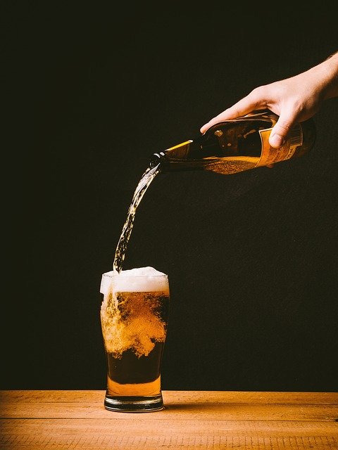 pouring beer on a glass